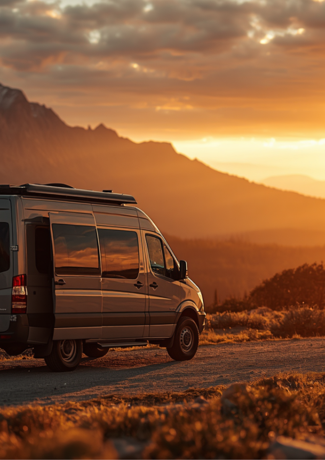 Off-grid camper van at golden hour with an outdoor shower running, showcasing a campervan water system